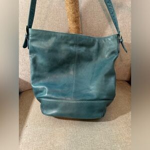 Genuine leather with adjustable strap. Silver accents. Excellent condition.